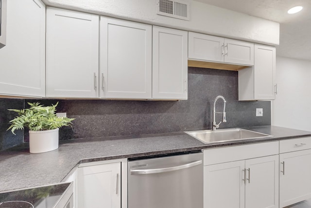 kitchen with white cabinetry, dishwasher, sink, and decorative backsplash