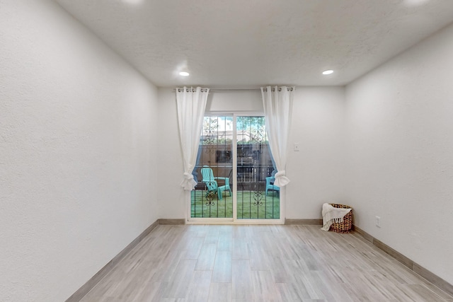 spare room featuring light wood-type flooring