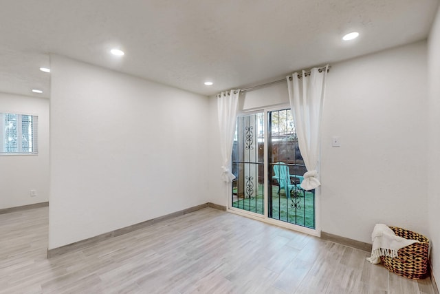 unfurnished room with light hardwood / wood-style floors