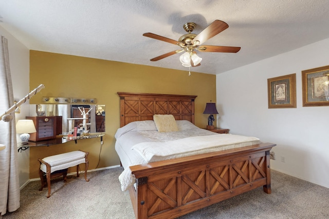 carpeted bedroom with ceiling fan and a textured ceiling