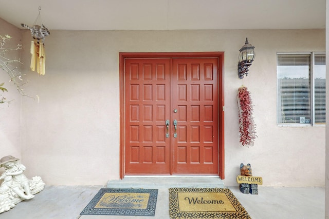 property entrance with stucco siding