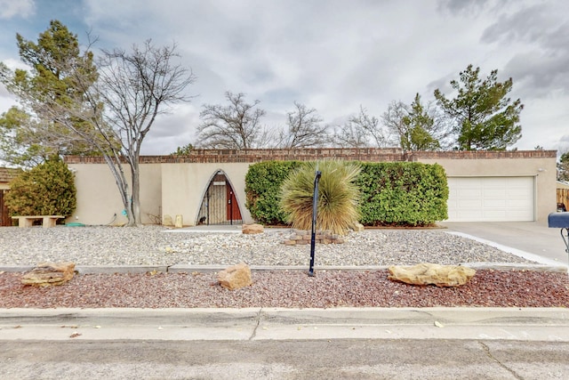 view of front of home with concrete driveway and stucco siding