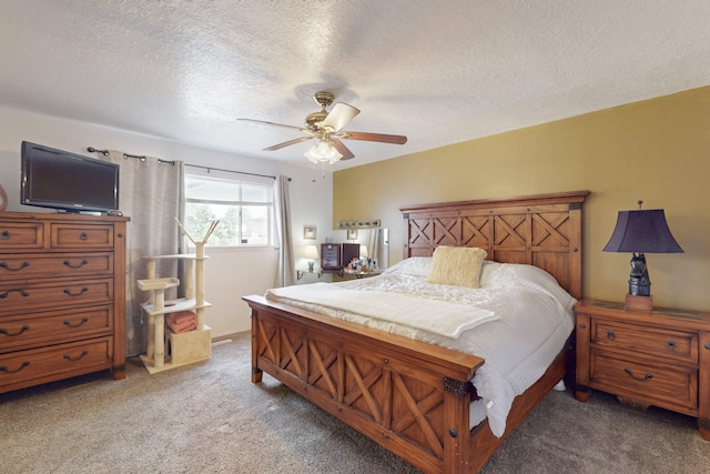 bedroom with carpet, a ceiling fan, and a textured ceiling