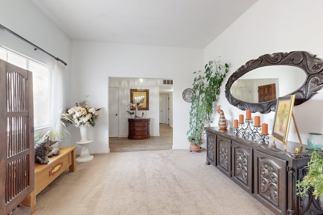 interior space with carpet and visible vents