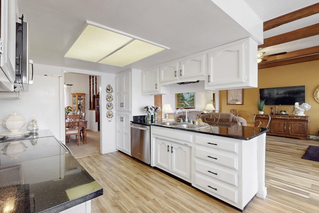 kitchen with stainless steel appliances, light wood-style flooring, white cabinets, a sink, and a peninsula