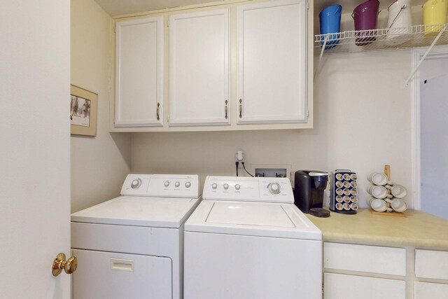 laundry area with cabinet space and separate washer and dryer