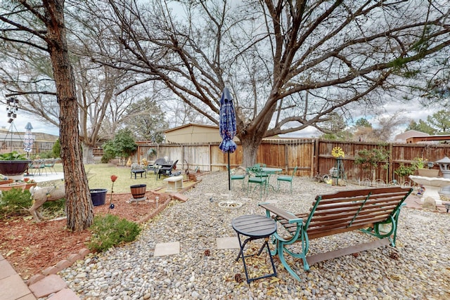 view of yard featuring a fire pit and a fenced backyard