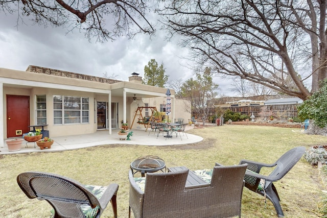 view of yard featuring an outdoor fire pit, a patio area, fence, and a ceiling fan