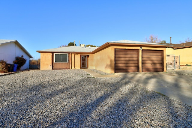 ranch-style house featuring a garage