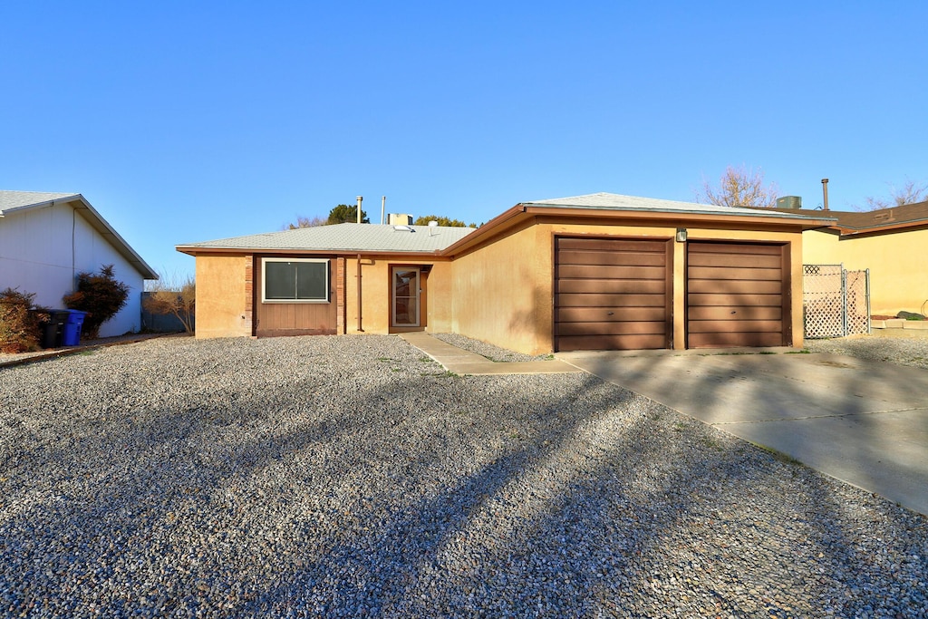 5005 Watercress Dr NE, Albuquerque, NM 87113 - view of front of home featuring stucco siding, driveway, and an attached garage