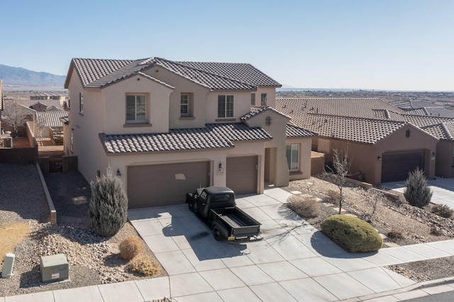 view of front facade with a garage and a mountain view