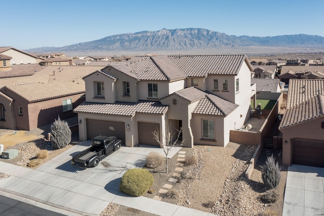 view of front of house with a mountain view and a garage