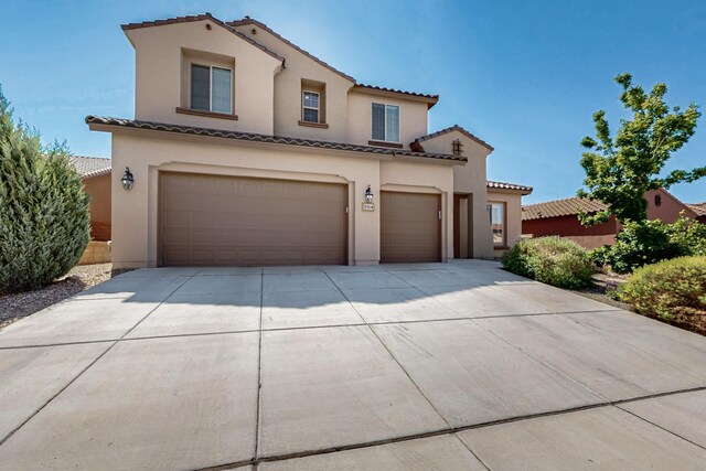 836 Mesa Roja Trl NE, Rio Rancho, NM 87144 - mediterranean / spanish home with an attached garage, a tile roof, driveway, and stucco siding