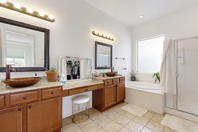 bathroom featuring vanity, shower with separate bathtub, and tile patterned floors