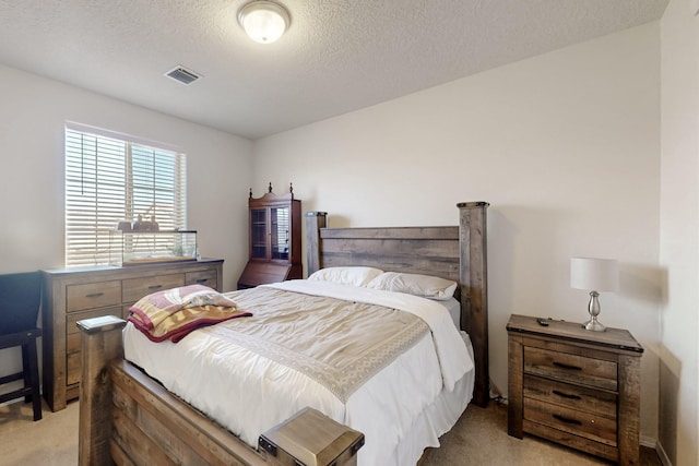 carpeted bedroom featuring a textured ceiling