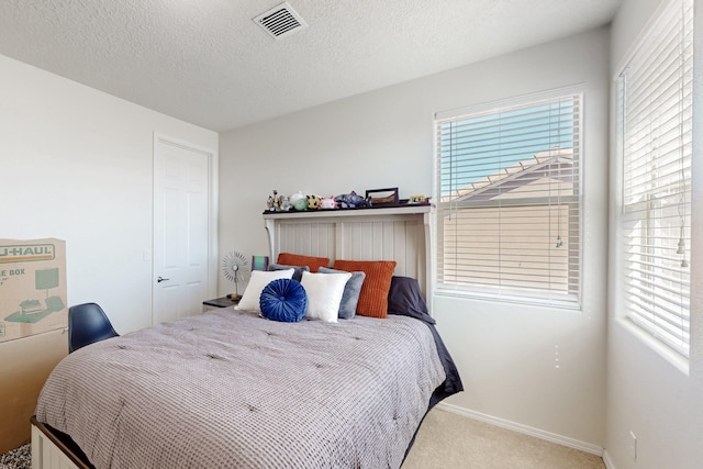 carpeted bedroom featuring a textured ceiling