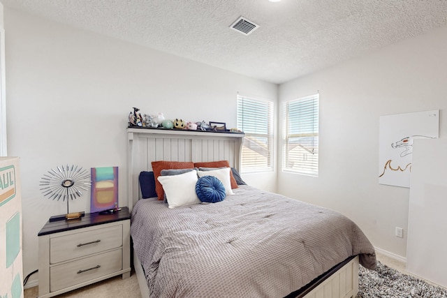 carpeted bedroom featuring a textured ceiling