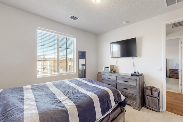 carpeted bedroom featuring a textured ceiling