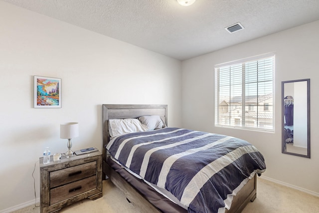 carpeted bedroom featuring a textured ceiling