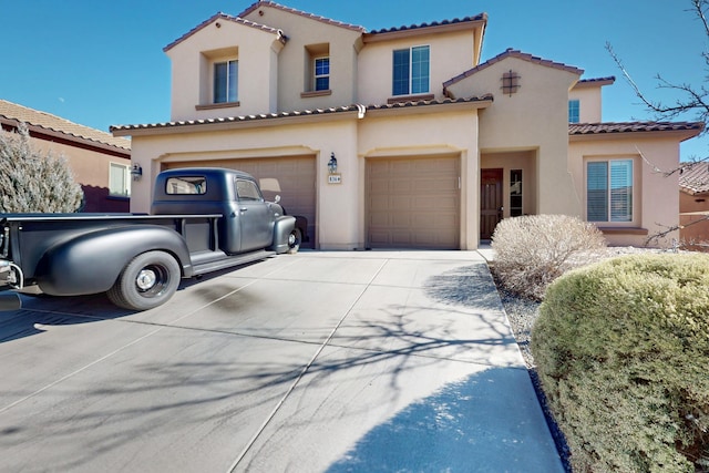 mediterranean / spanish house with a garage