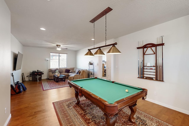 playroom with pool table, hardwood / wood-style floors, and a textured ceiling