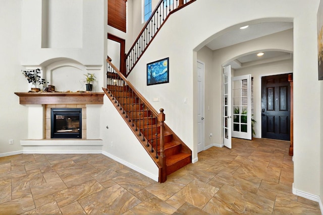 836 Mesa Roja Trl NE, Rio Rancho, NM 87144 - stairs with stone tile flooring, baseboards, a fireplace, and recessed lighting
