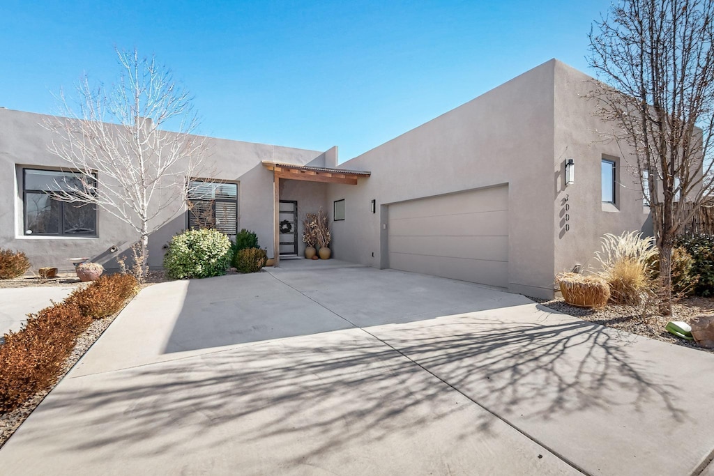 pueblo-style home featuring a garage