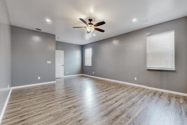 empty room with light hardwood / wood-style floors and ceiling fan