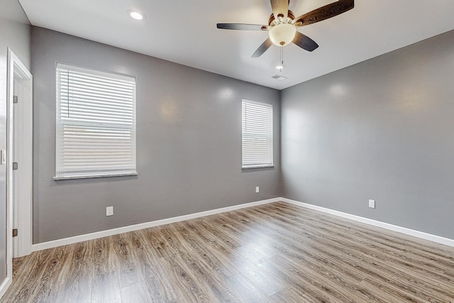 spare room featuring ceiling fan and hardwood / wood-style floors