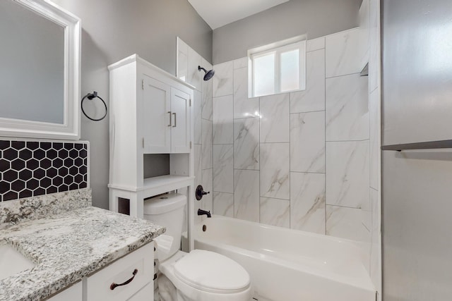 full bathroom with backsplash, toilet, vanity, and tiled shower / bath combo