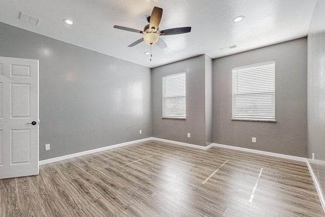 unfurnished room with ceiling fan and wood-type flooring