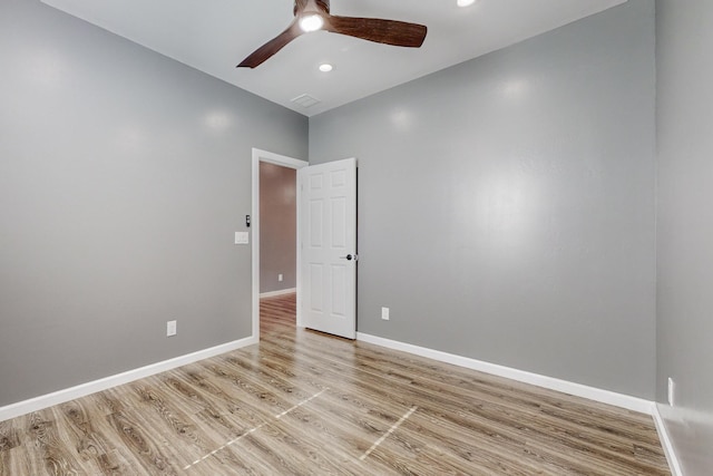 spare room with ceiling fan and light wood-type flooring