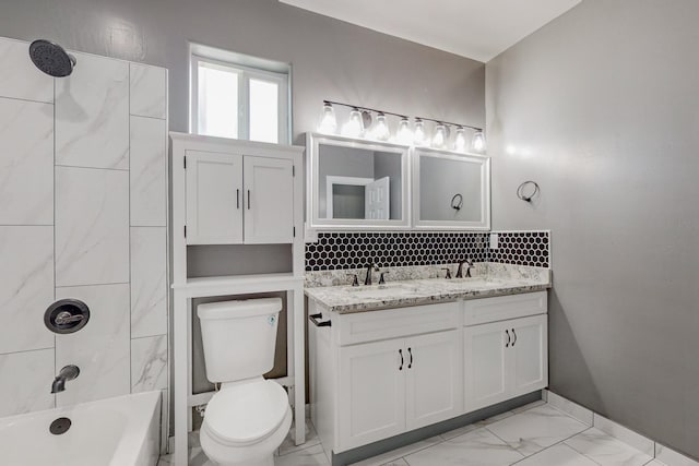 full bathroom with tiled shower / bath combo, vanity, and toilet