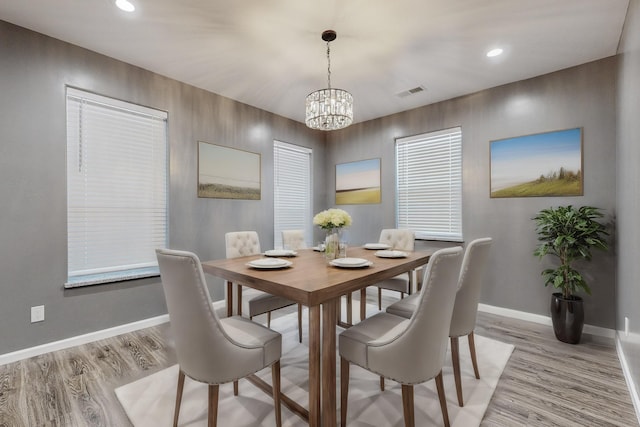 dining room featuring an inviting chandelier and light hardwood / wood-style floors