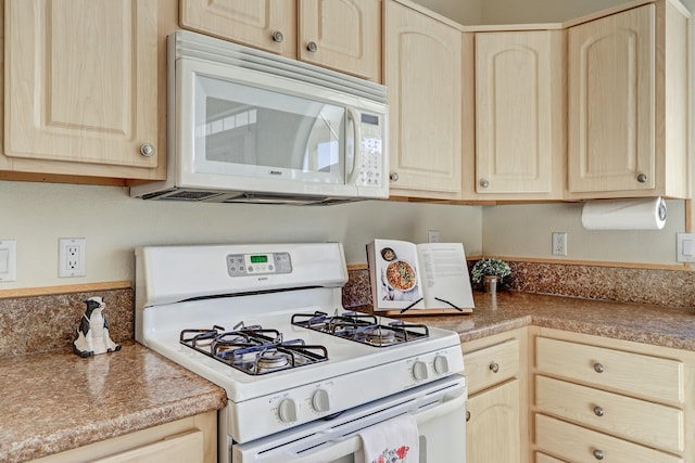 kitchen featuring white appliances and light brown cabinets