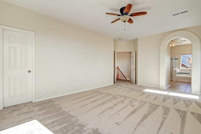 spare room with light carpet and ceiling fan