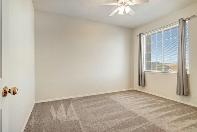 carpeted empty room with ceiling fan and a textured ceiling