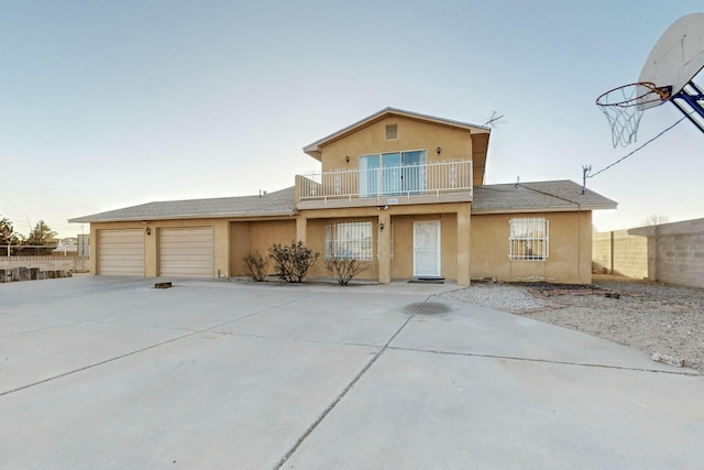 view of front of house featuring a garage and a balcony