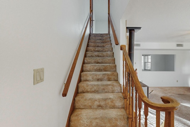 stairs featuring carpet floors