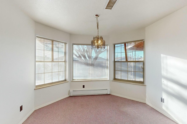 carpeted spare room with a baseboard heating unit, a wealth of natural light, and a chandelier