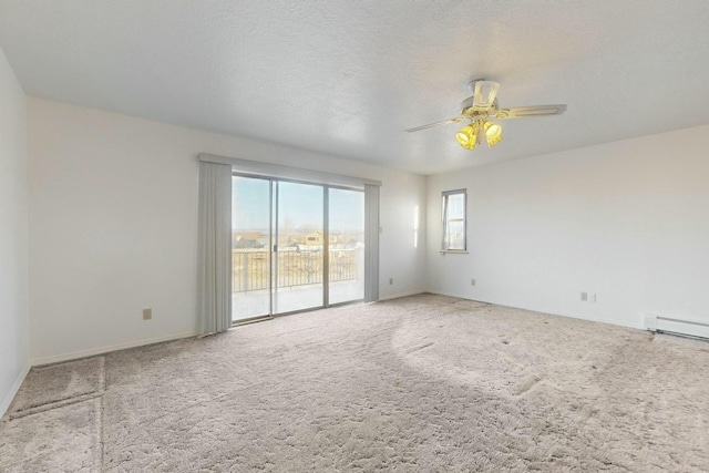 spare room with ceiling fan, carpet flooring, a textured ceiling, and a baseboard radiator