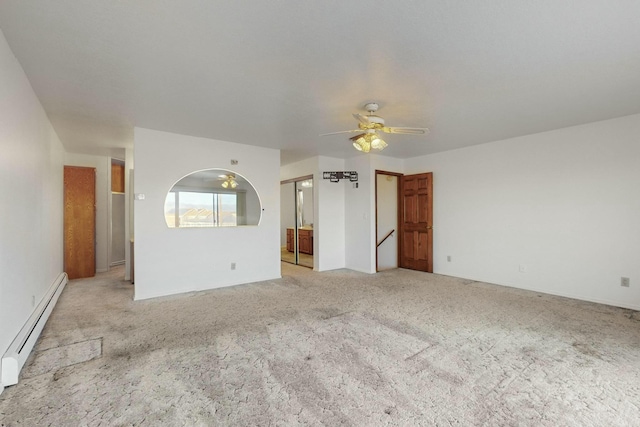 interior space featuring ceiling fan, light colored carpet, and a baseboard heating unit