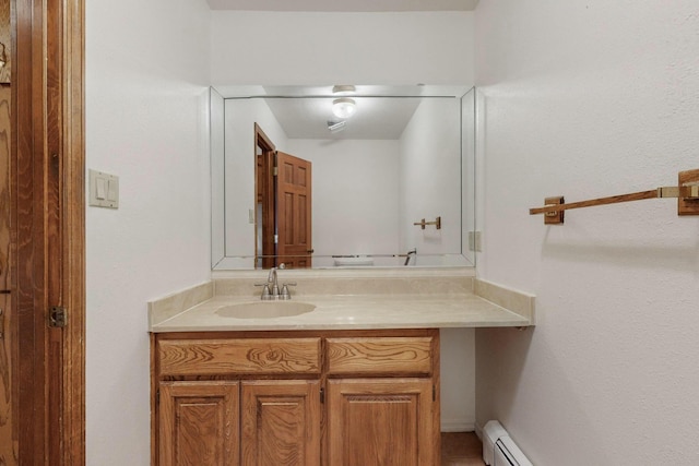 bathroom with vanity and a baseboard heating unit