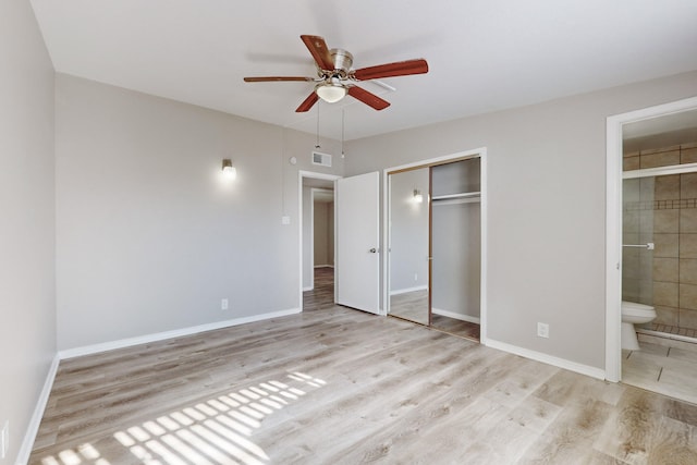 unfurnished bedroom with ensuite bath, a closet, and light wood-type flooring