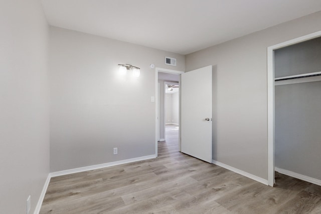 unfurnished bedroom with light hardwood / wood-style floors and a closet