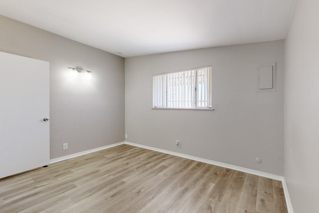 spare room with light wood-type flooring