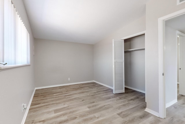 unfurnished bedroom with a closet and light wood-type flooring