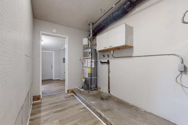 utility room featuring secured water heater