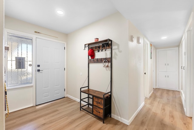 foyer entrance with light wood-style floors, recessed lighting, and baseboards