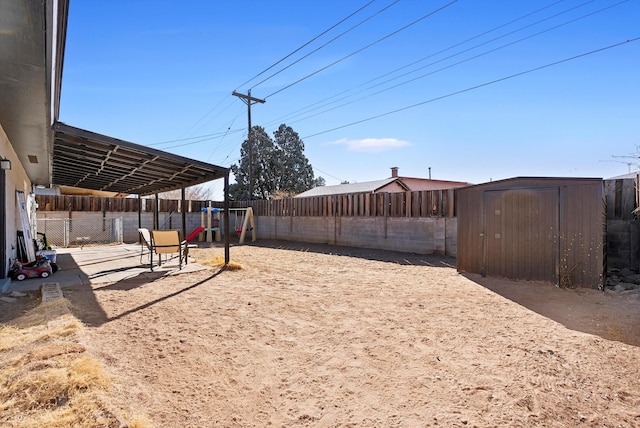 view of yard featuring a storage shed and a playground